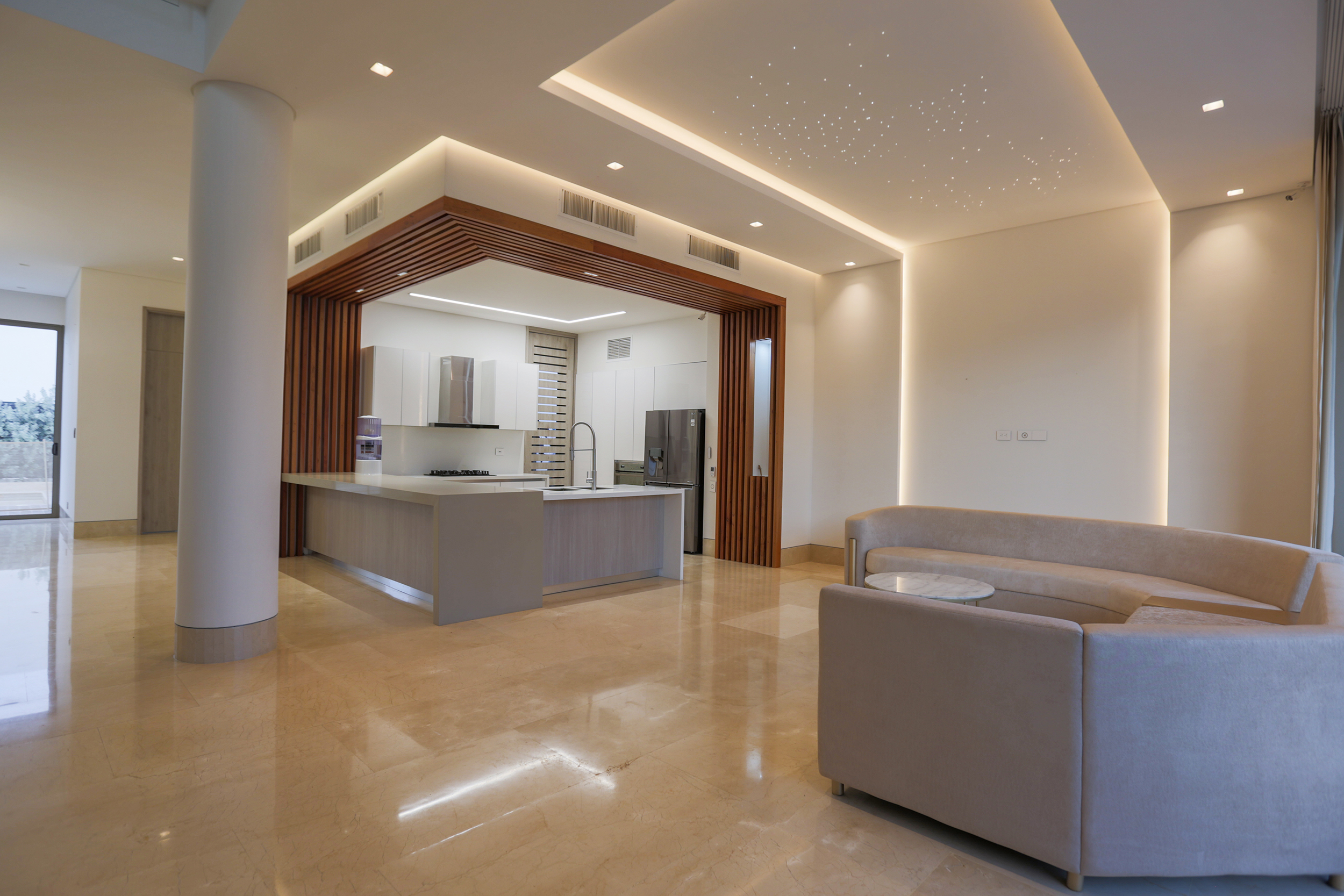 Ante sala de la Cocina abierta de Casa Sarria 31 03 enmarcada por listones de madera.